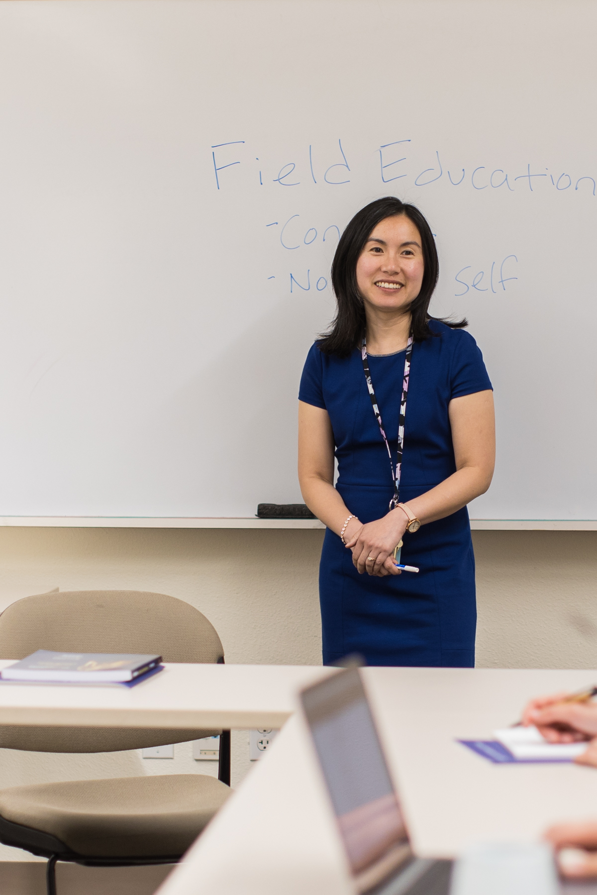 Faculty member in front of whiteboard